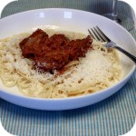 Beef stewed in tomato sauce with noodles